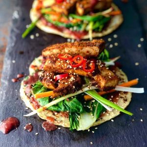 An image of crispy teriyaki tofu with a chinese plum sauce