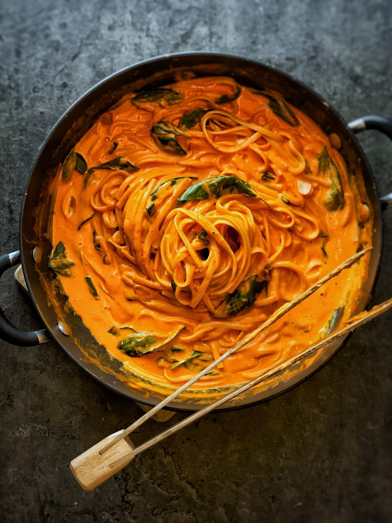 creamy red pepper pasta in pan