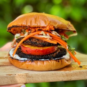 An image of Jerk mushroom, charred Peach & Caribbean Picklese burger