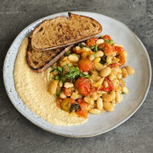 a photo of Confit Roasted Tomatoes with Garlic, Basil & Butter Beans